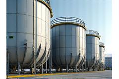 Insulated chemical storage tanks with safety measures visible, conveying containment and safety.
